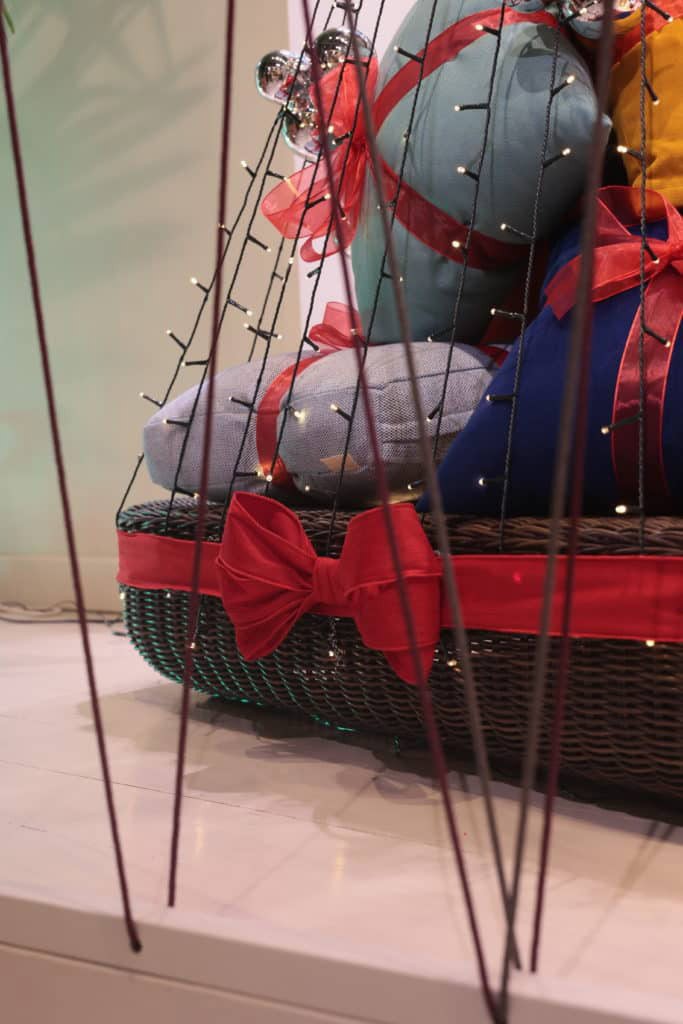 Basket With Wrapped Gifts And Decorative Lights For Christmas.