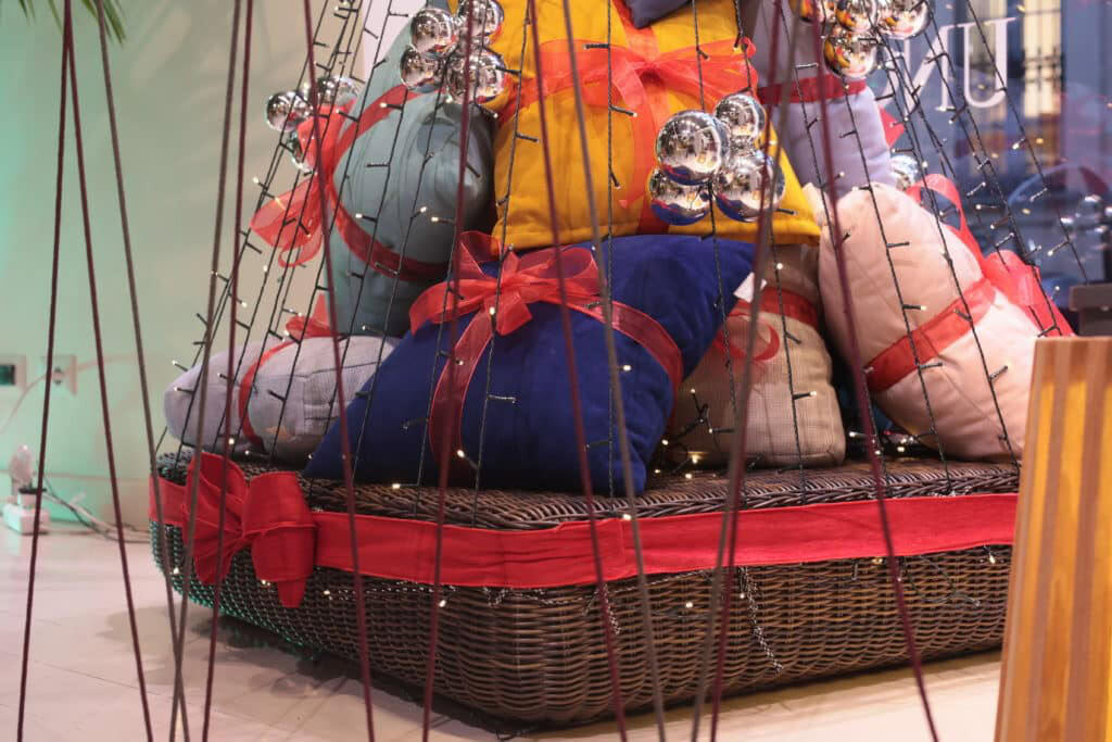 Colorful Fabric Dolls And Glass Ornaments In A Decorative Basket.