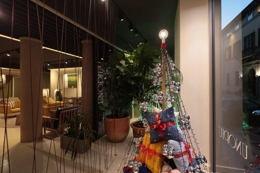 Festive Christmas Display With Decorated Tree And Gifts At Architects Srl.