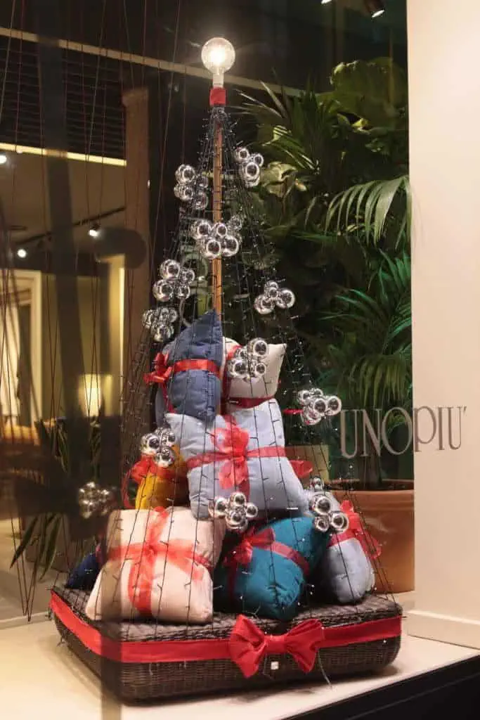 Decorative Christmas Tree With Wrapped Gifts And Ornaments At Unopiu'.