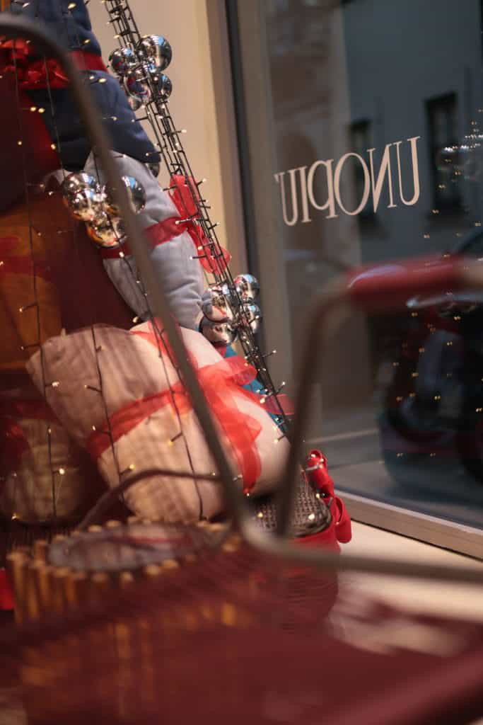 Festive Christmas Display With Ornaments And Decorations In A Store Window.
