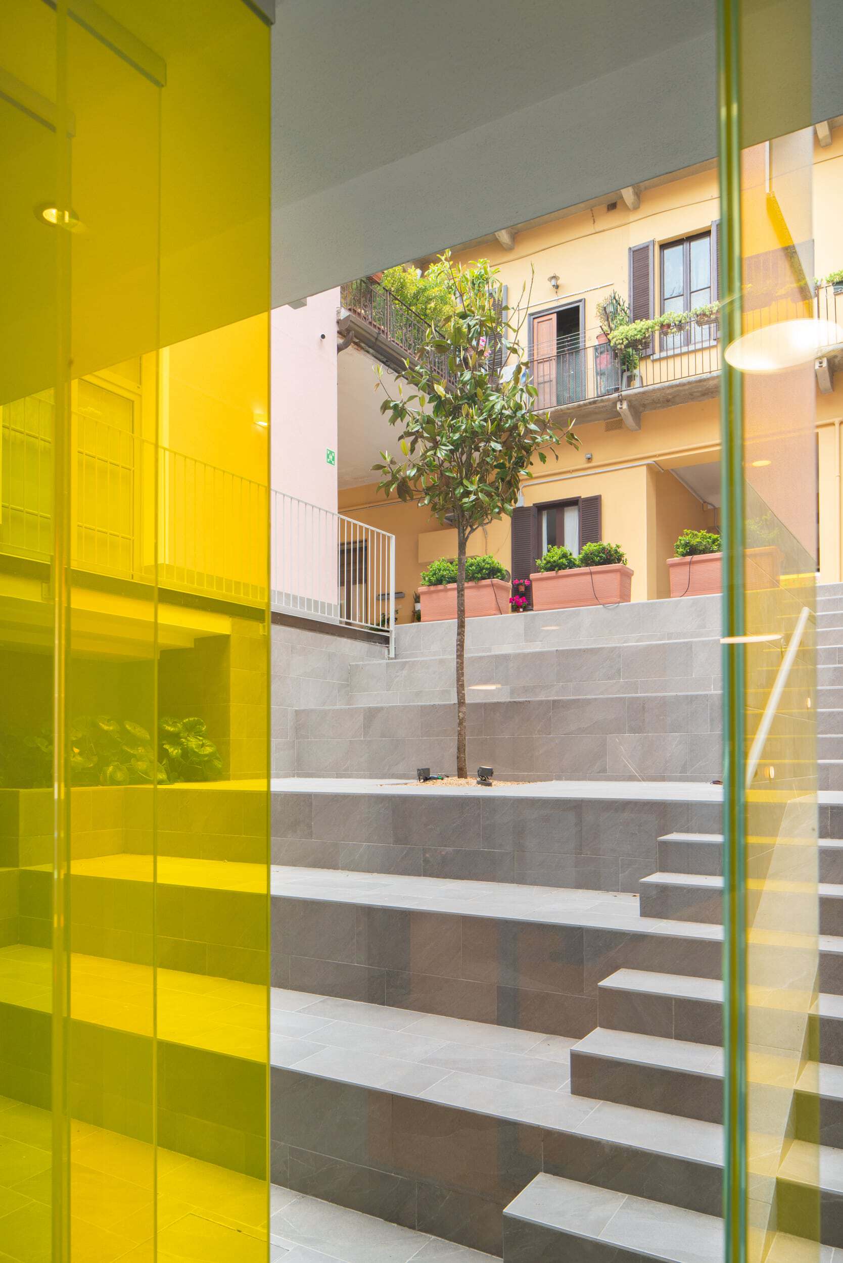 Modern courtyard with stairs and greenery in Collegno 7.