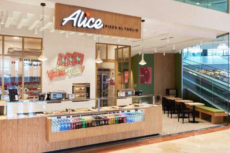 Alice Pizza Counter Inside A Modern Shopping Mall With Seating Area.