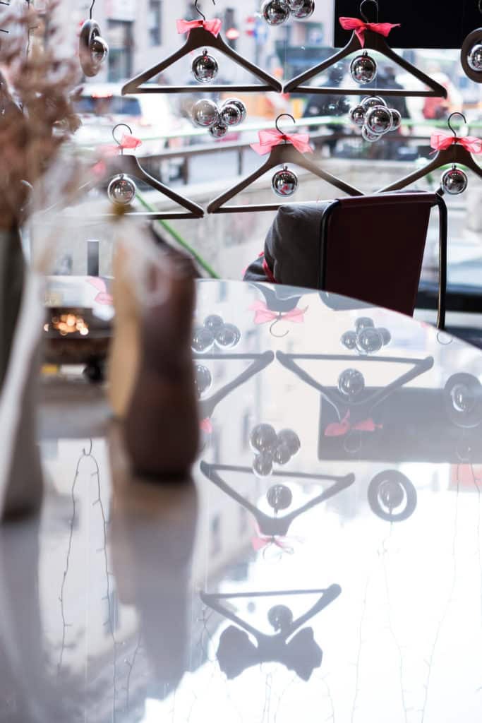 Decorative Glass Ornaments Hanging With Pink Ribbons In A Modern Interior Setting.