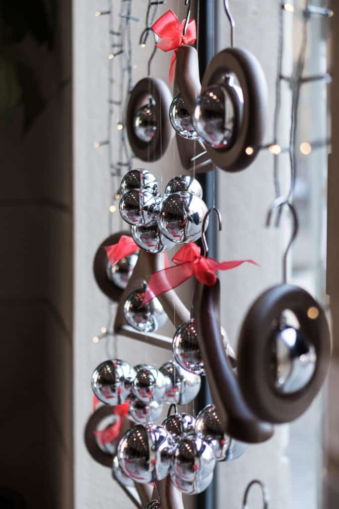 Decorative Hanging Ornaments With Red Ribbons And Reflective Silver Balls.