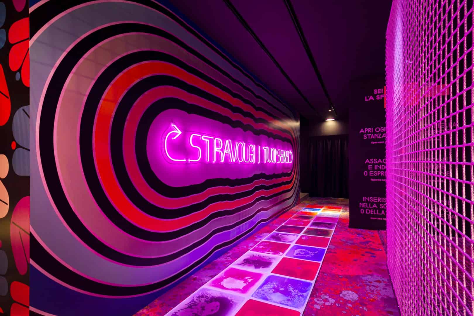 Colorful neon-lit corridor at Museum of Senses with vibrant wall and floor designs.
