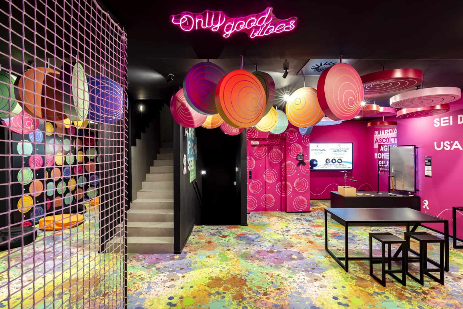 Colorful Interior With Hanging Circular Art And Neon Sign At Museum Of Senses.