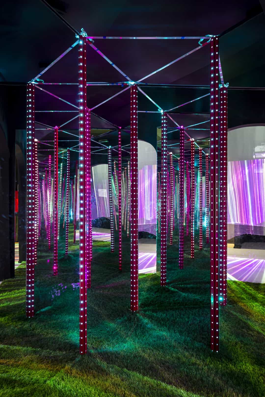 Colorful illuminated art installation with vertical poles and LED lights at Museum of Senses.