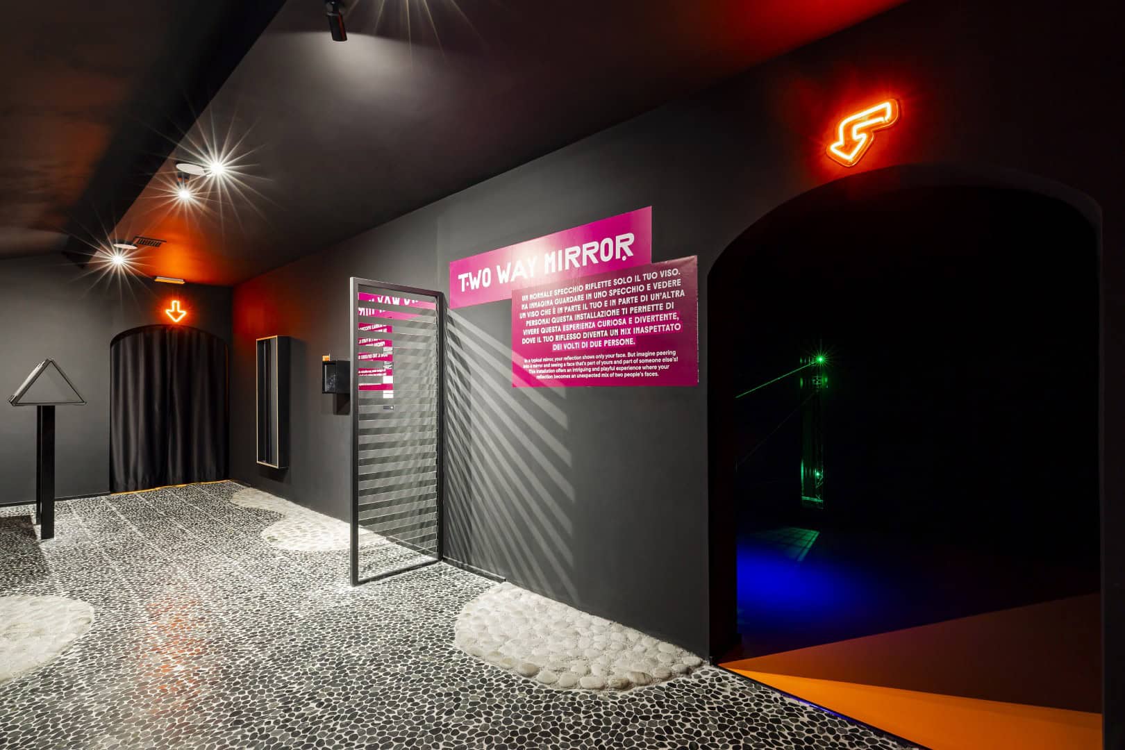 Interactive exhibit at Museum of Senses with neon signs and textured walls.