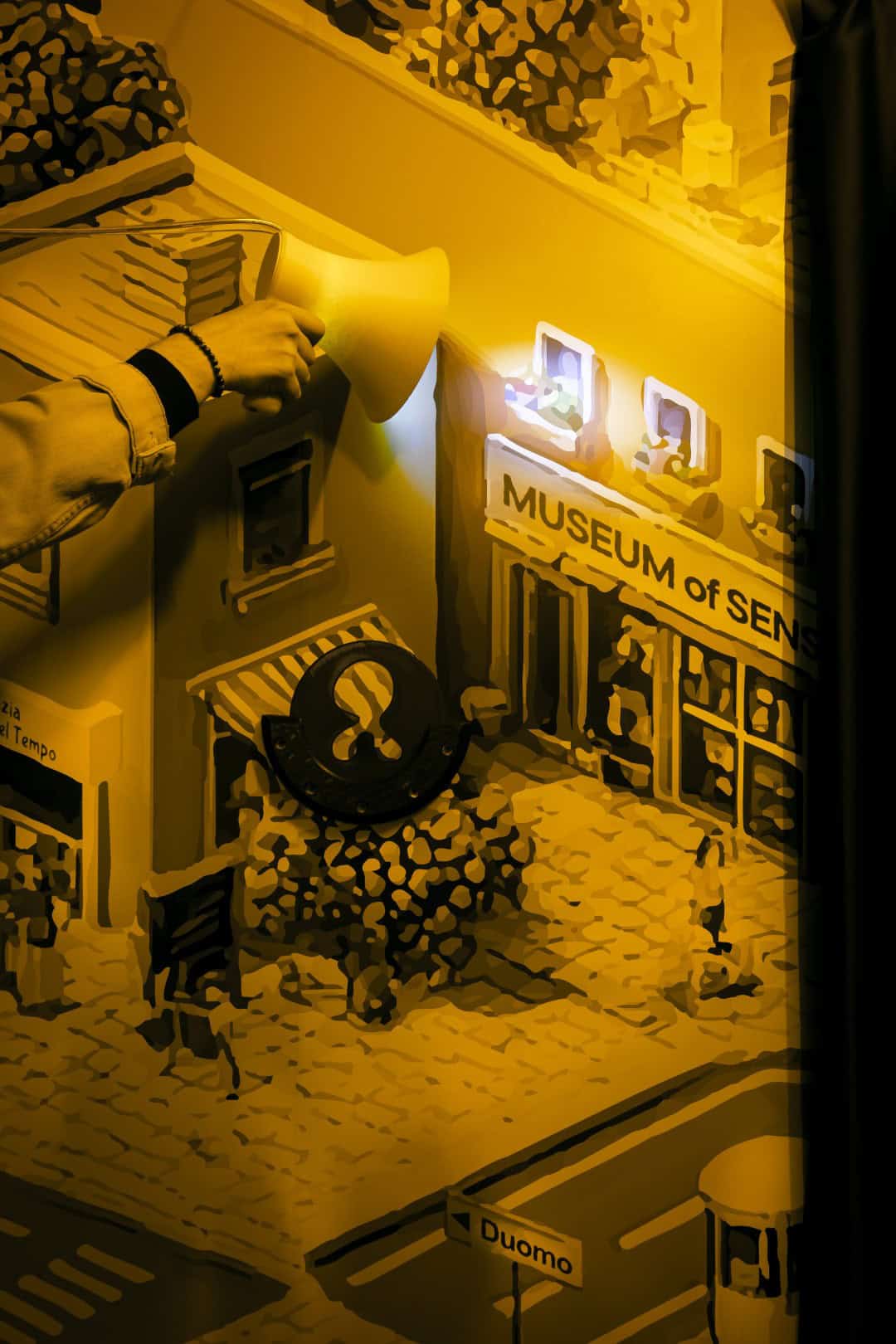 Miniature museum scene with signs and tiny figures for sensory experience.