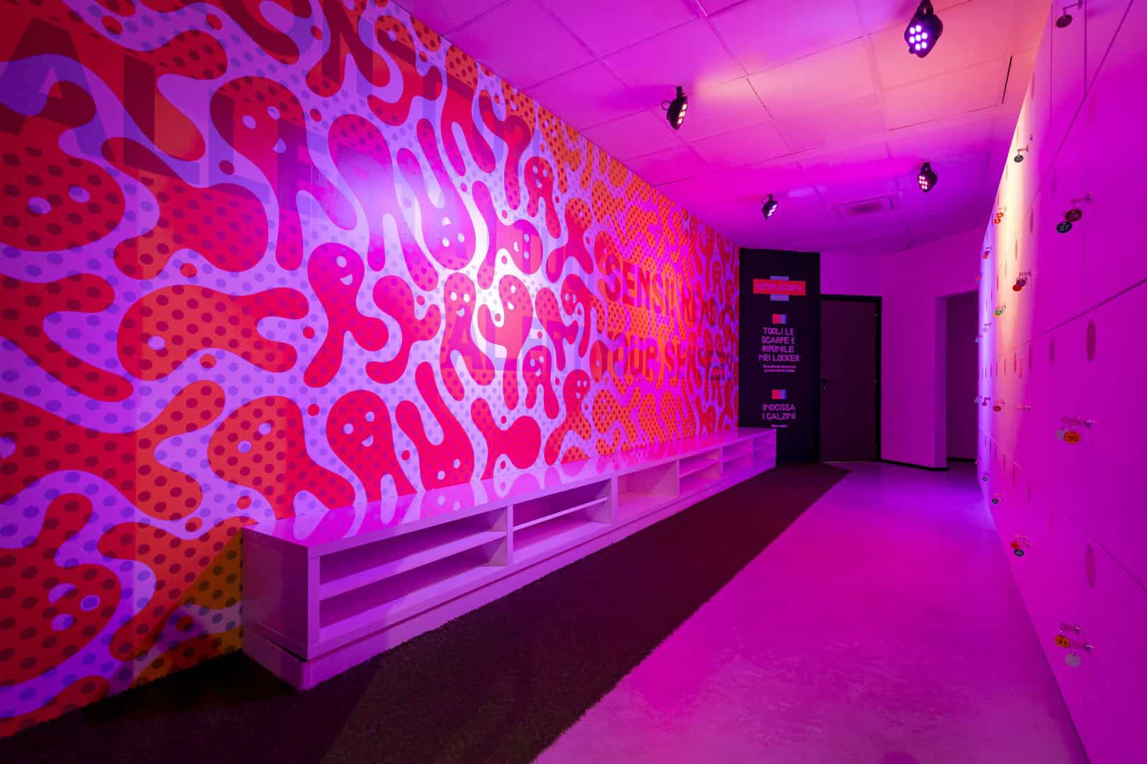 Vibrant pink and purple sensory exhibit with patterned wall at Museum of Senses.