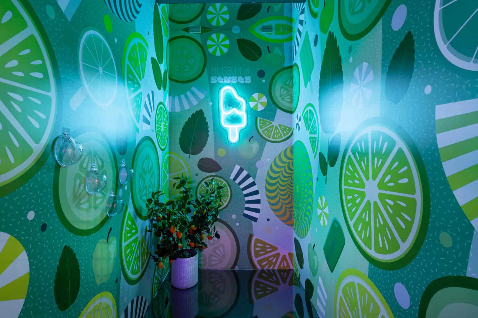 Colorful lime-themed interior design at the Museum of Senses by arcHITects srl.