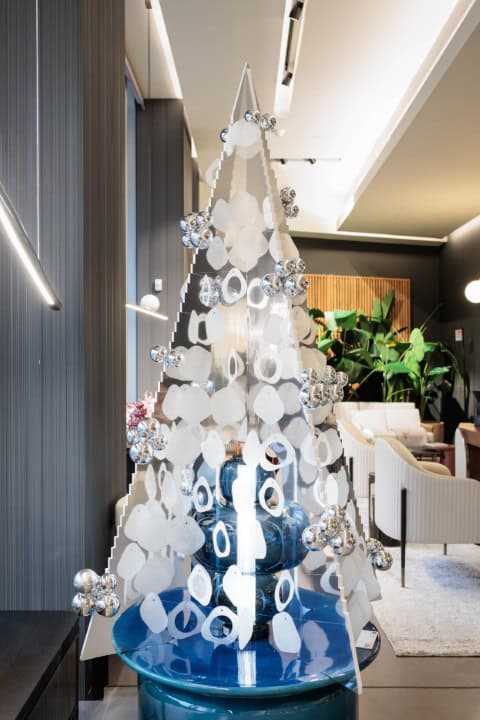 Modern White Christmas Tree With Silver Ornaments In Stylish Interior.