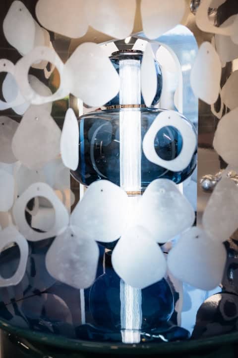 Decorative Glass Perfume Bottle Surrounded By White Paper Hearts For Christmas 2025.