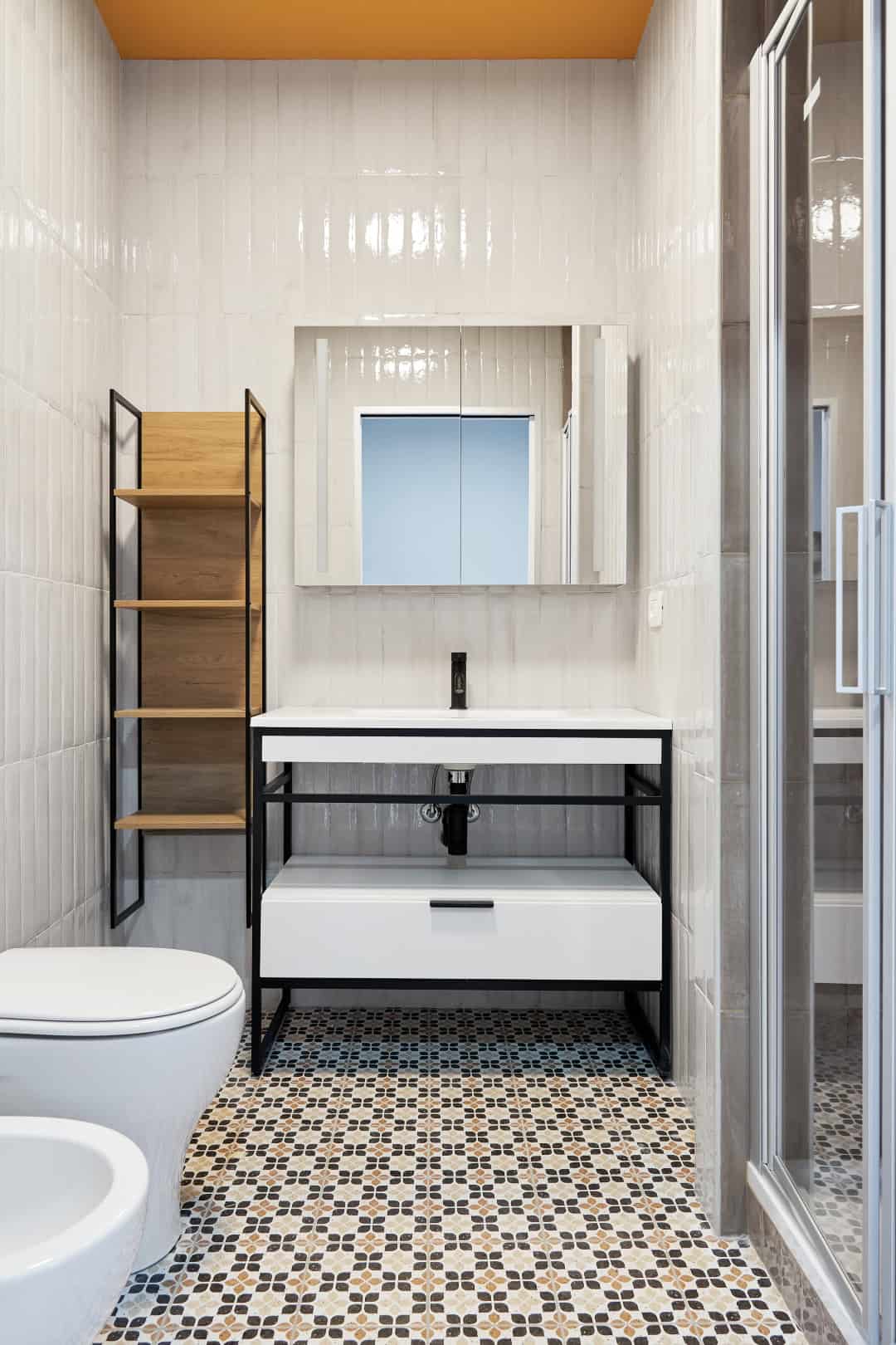 Modern bathroom with minimalist design and black metal accents.