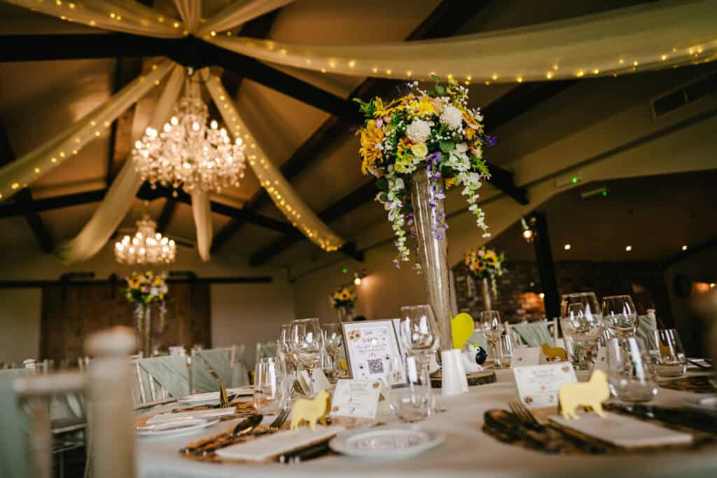 Elegant wedding reception at Hyde Bank Farm with floral centrepieces and ambient lighting.