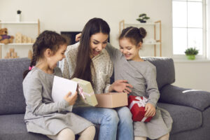 &nbsp;>thisisjustarandomplaceholder<Excited young woman opens the present her little children gave her on Mother's Day | Iberian Press®&nbsp;