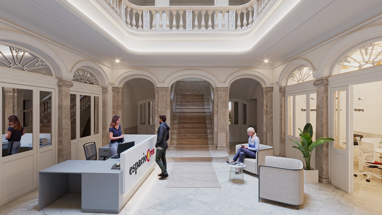 Elegant marble lobby with a curved reception desk and a man speaking to a receptionist; stylish seating and arches line the hall.