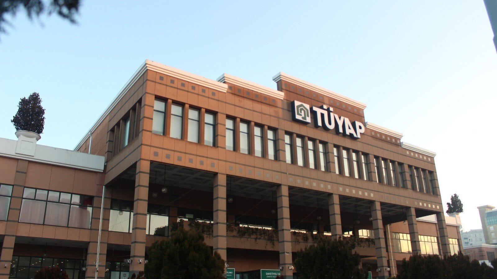 TÜYAP conference center facade: brown brick building with tall windows and a large TÜYAP sign on the front.