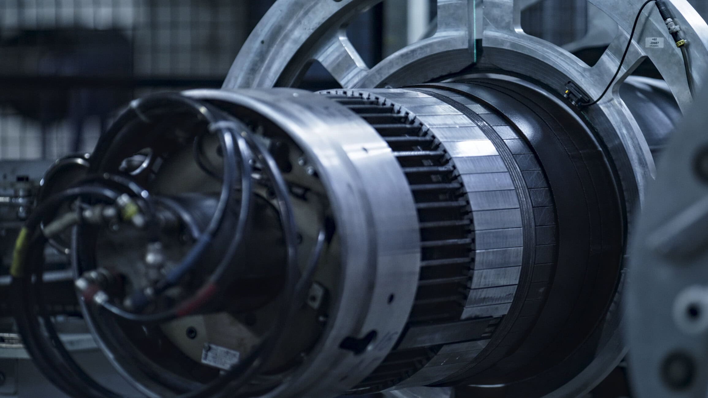 Close-up of a large industrial turbine component with circular metal housing and visible wiring.