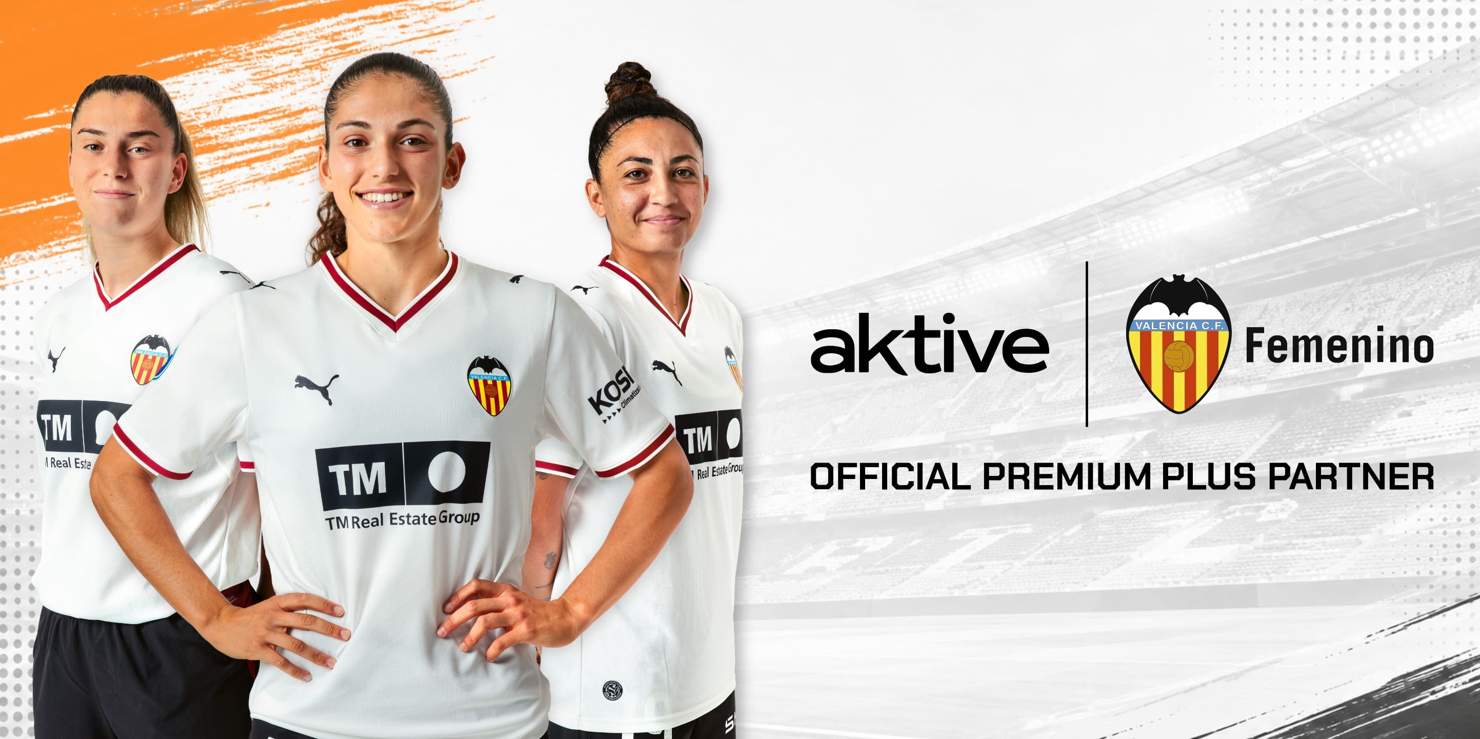 Three Valencia CF Femenino players pose in white jerseys with sponsor logos visible (TM Real Estate) and the Active branding on the right side of the image.