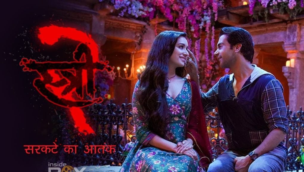 A romantic scene from Inside Box Office featuring a smiling couple in a colorful, festive setting with flowers and warm lighting, highlighting Bollywood entertainment and love stories.