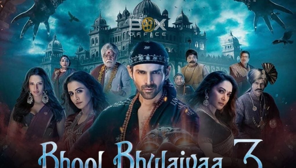 Mumbai movie poster for Bhoot Bhulaiyaa 3 with diverse cast in traditional attire in front of haunted mansion spooky background with flying bats and dark clouds.