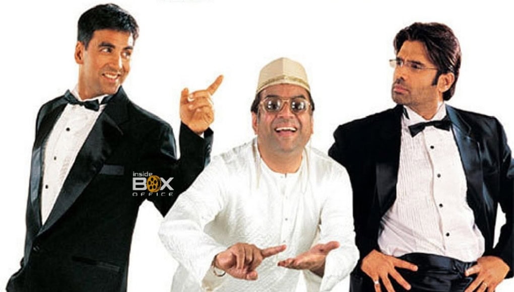 Hera Pheri 3 feature Men in suits and traditional attire making humorous gestures for a movie-themed promotional photo.