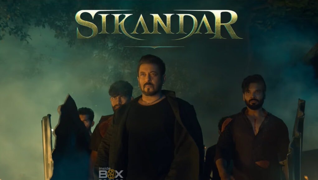 sikandar feature images 4 Vigorous group of men walking through a smoky, fiery outdoor scene with a dark, intense atmosphere, promoting the fantasy action film "Sikandar" to fans of Indian cinema and blockbuster thrillers.