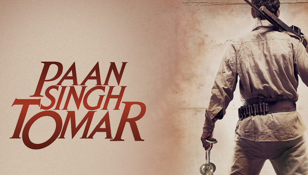 paan singh toamr feature images Resilient soldier holding medallions during Indian independence movement protest against British rule.