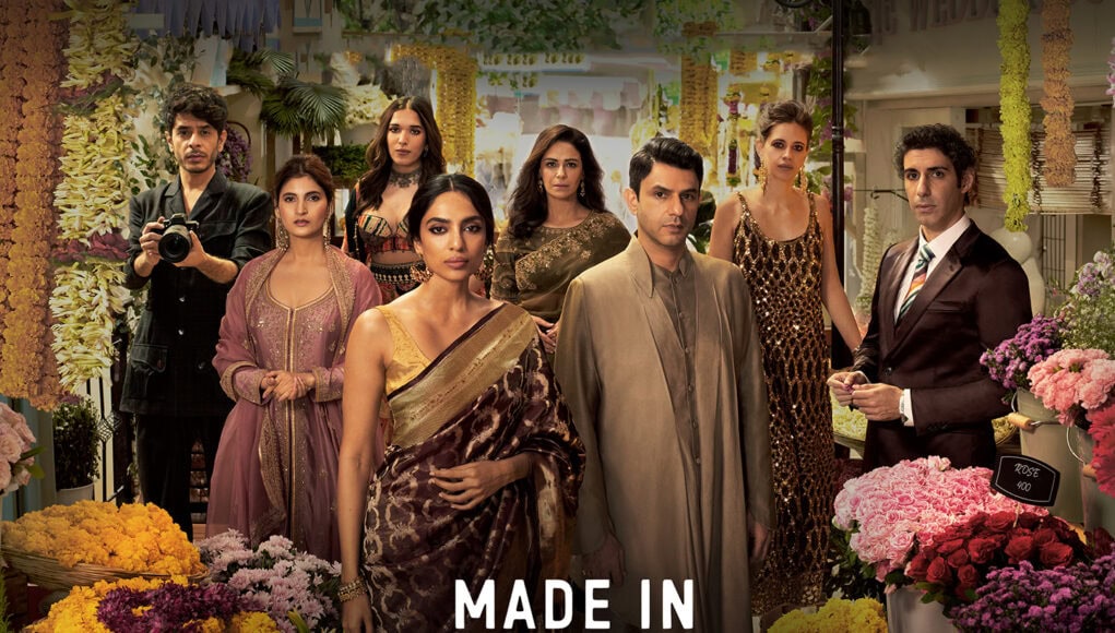 Brightly dressed cast members of "Made in Heaven" posing amid colorful flower arrangements in a floral shop, showcasing costumes and key characters in an Indian drama series about relationships and societal issues.