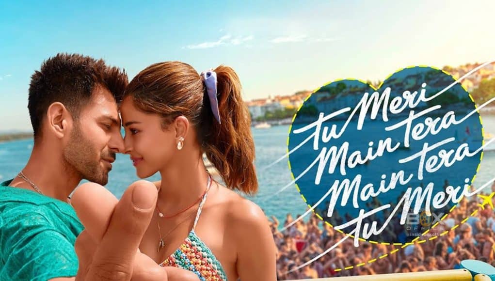 Romantic scene of a young couple at the beach, embracing close with their foreheads touching during sunset, capturing love and happiness in a lively summer setting.