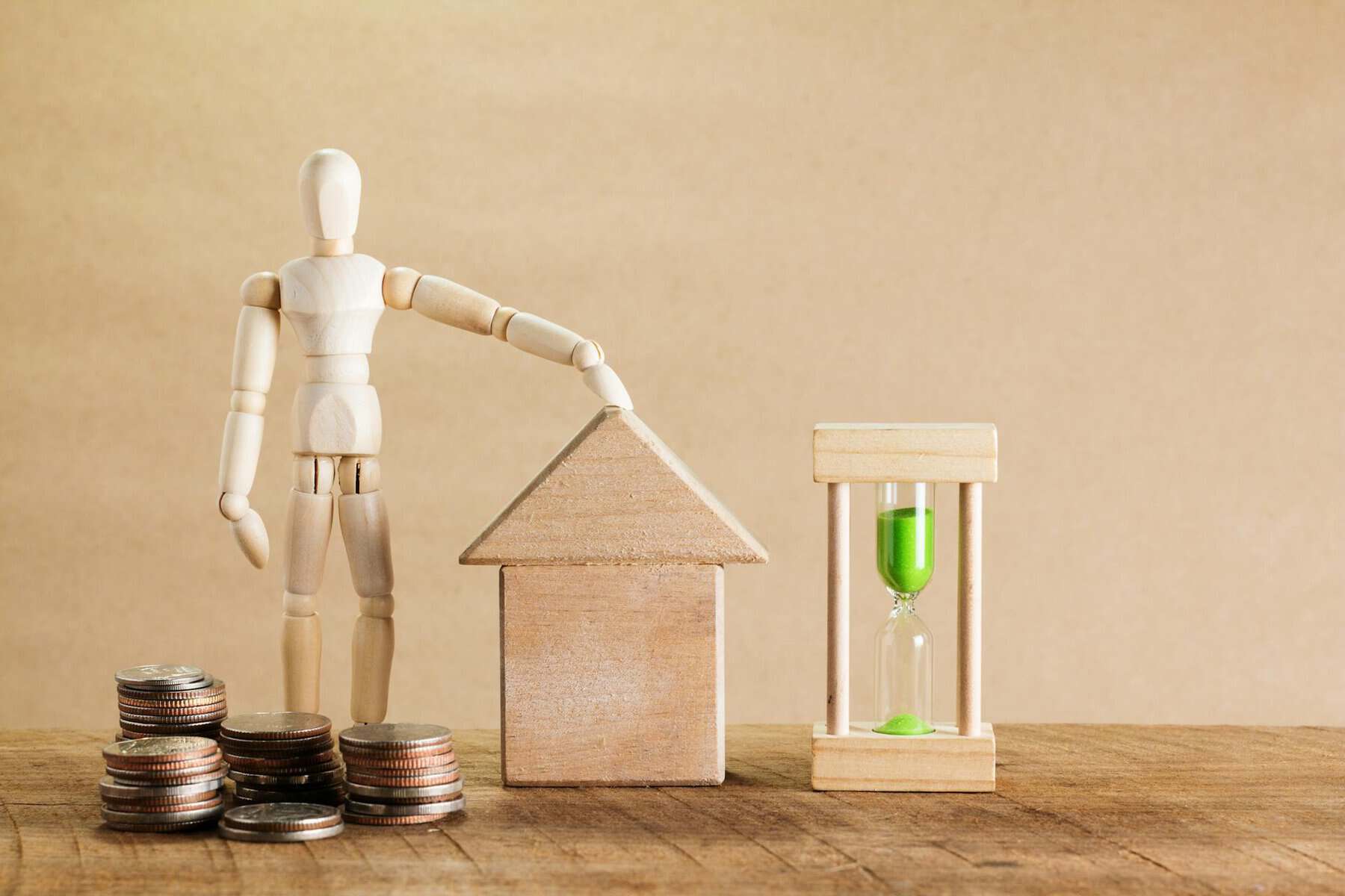 House model with coins, hourglass, and figure representing mortgage planning