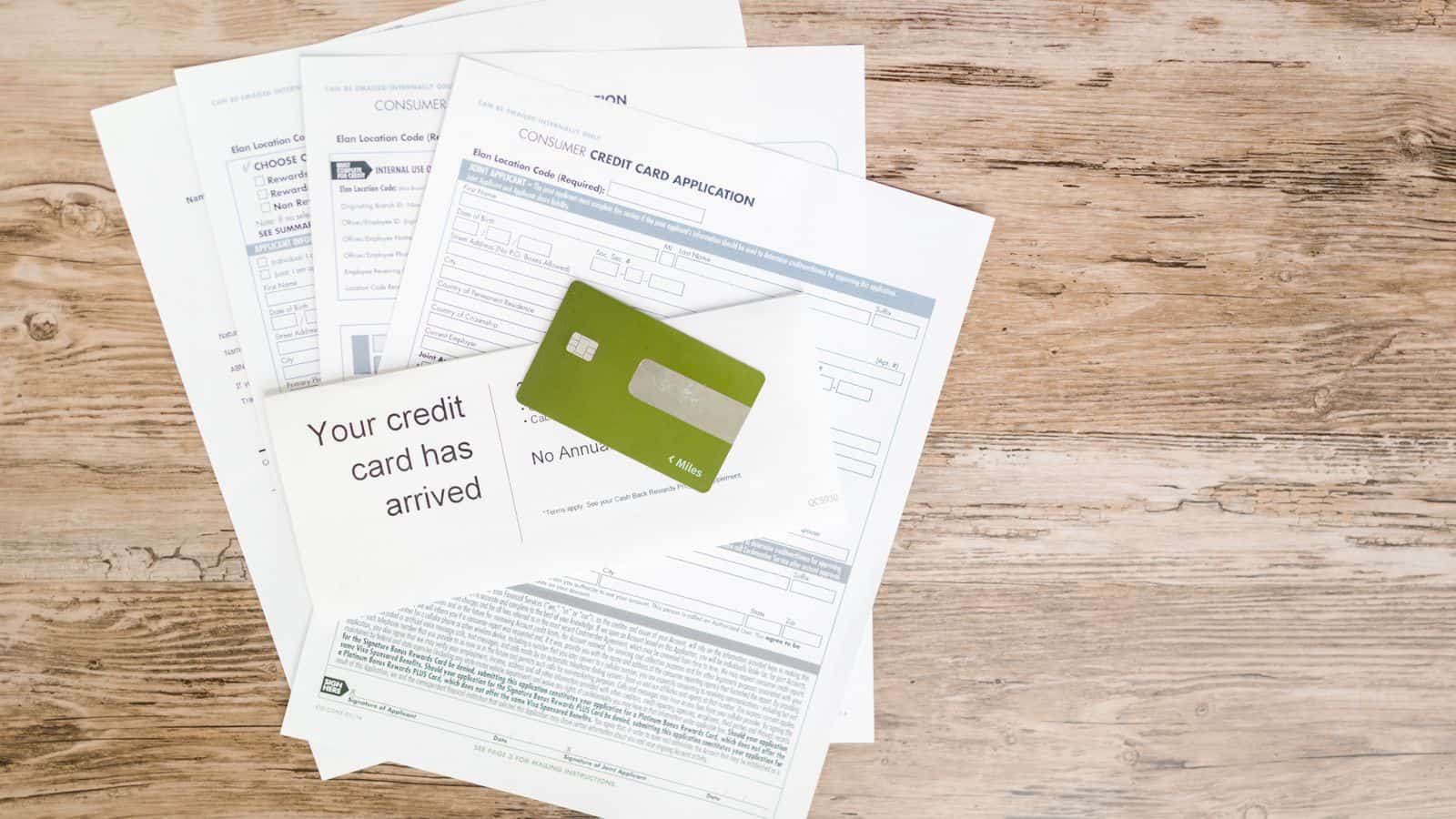 A credit card and consumer credit application on a desk representing the credit check behind a Las Vegas rental application