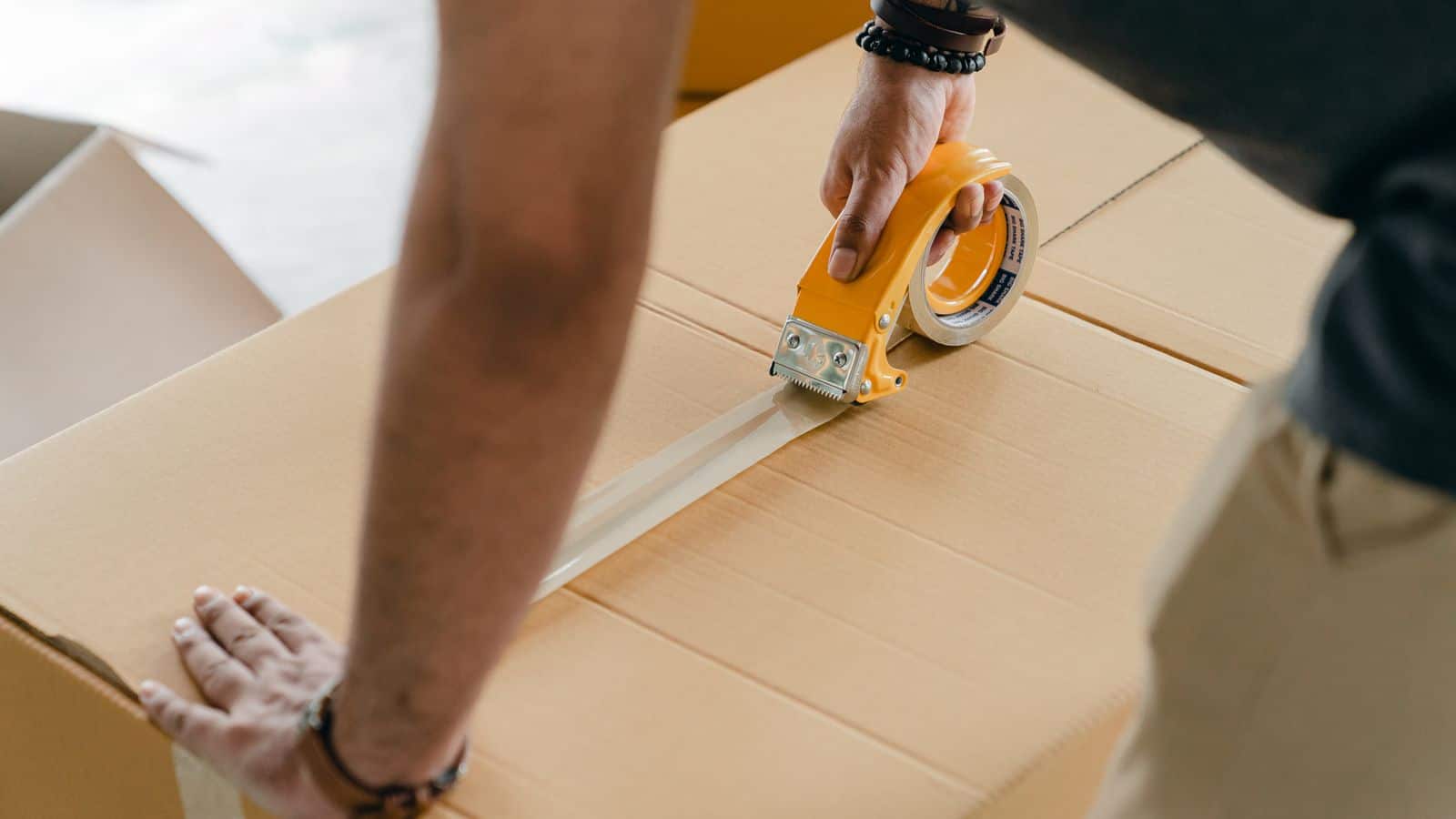 Young person carrying moving boxes into a first apartment