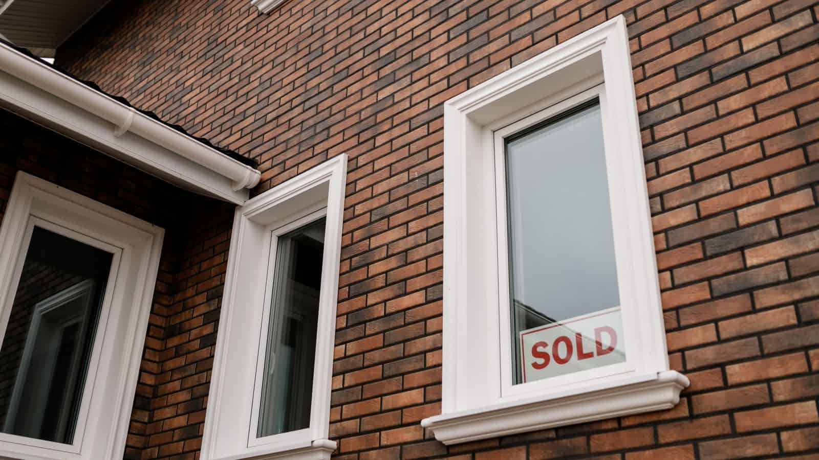Brick house with a sold sign in the front yard