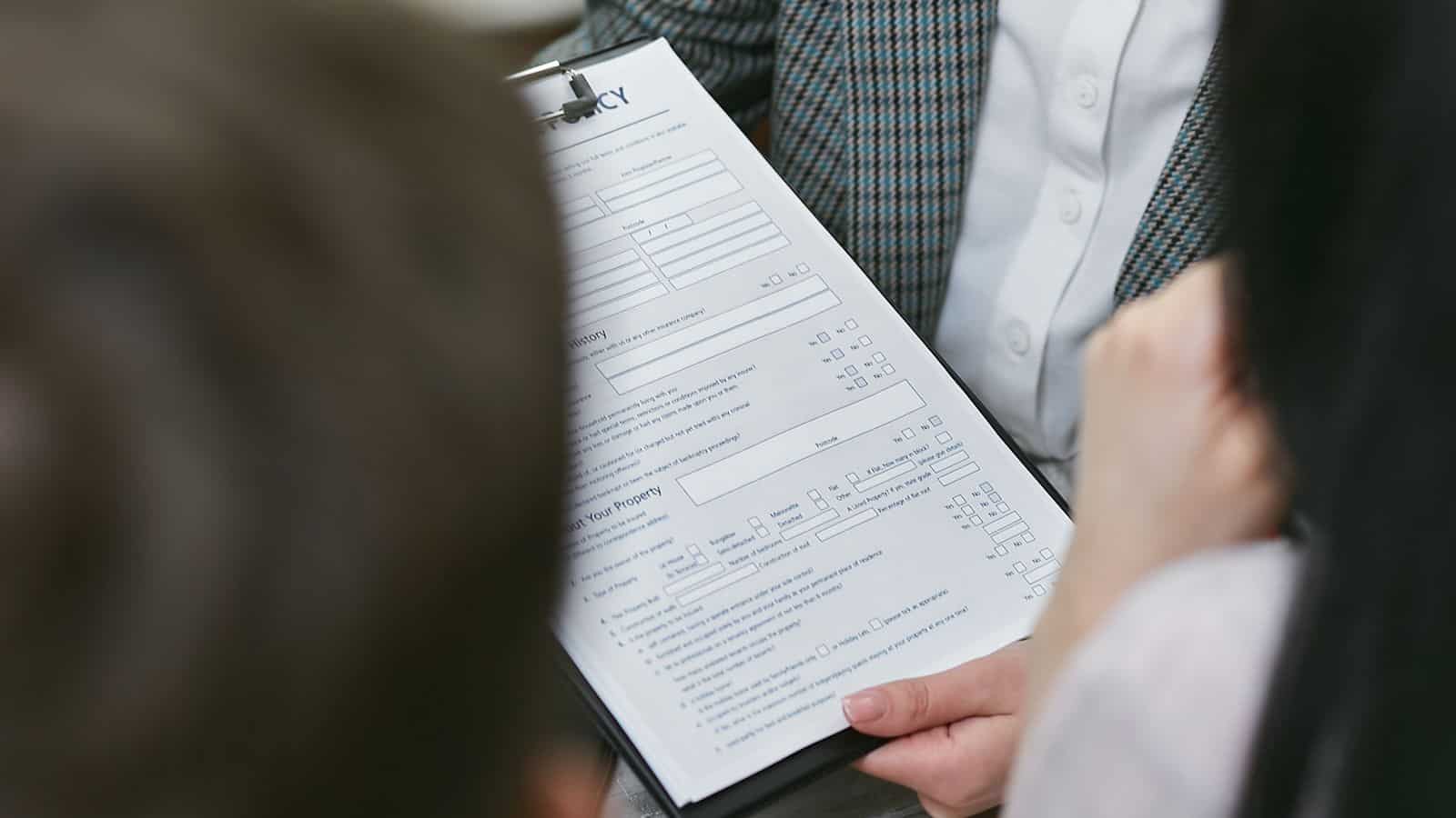 A landlord and tenant reviewing a rental agreement together at lease renewal time