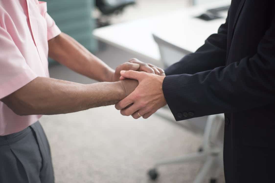 Property owner and manager shaking hands over a Las Vegas property management agreement