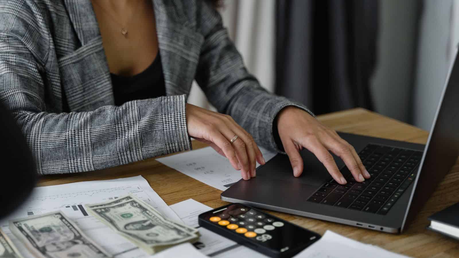 Rental owner reviewing depreciation figures with a laptop calculator and financial documents