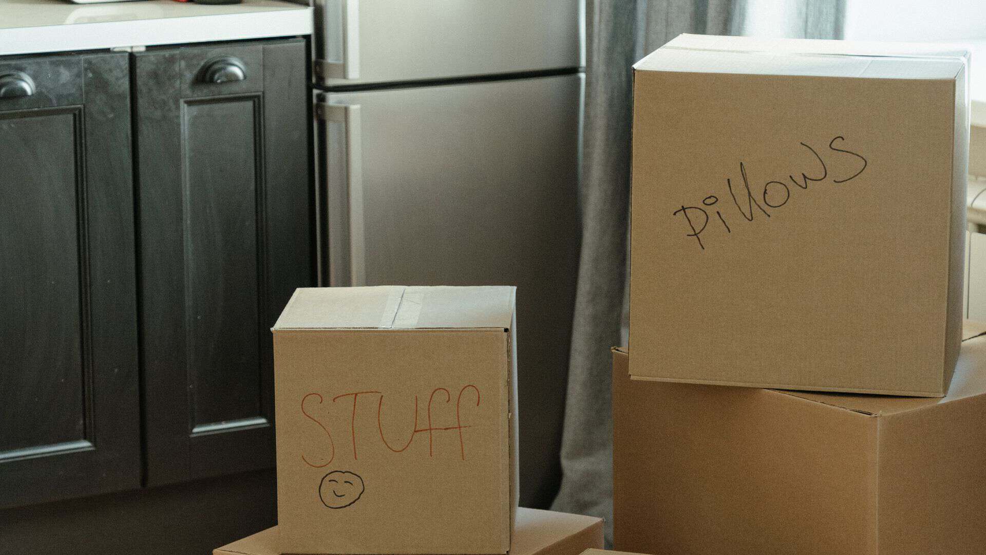 Renter packing moving boxes while deciding whether to renew a Las Vegas apartment lease