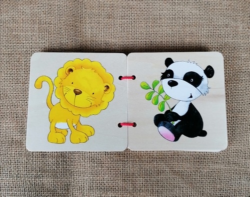 Hochwertige Holzfiguren eines Löwen und eines Pandas, handgefertigt für liebevolle Kindergeschenke.