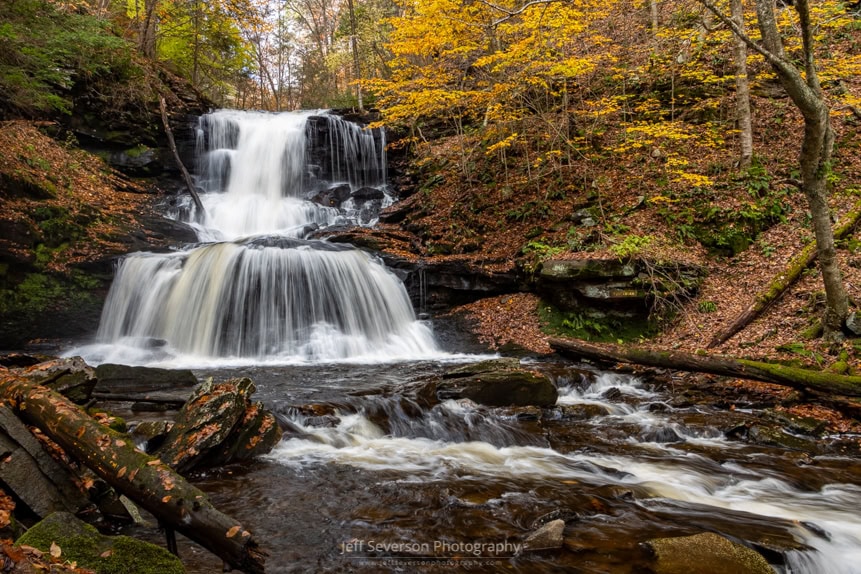 A photograph of the 47 foot Tuscarora Falls at Ricketts Glen State Park in PA on an autumn morning.