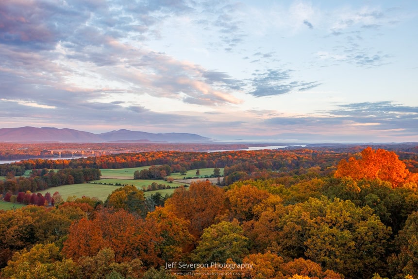 The golden hour of sunrise across Northern Dutchess County from atop the 80 foot tall fire tower at Ferncliff Forest in Rhinebeck, NY on an October morning.