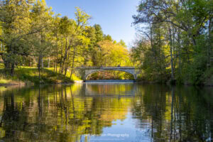 Spring foliage reflected on the Crum Elbow Creek as it flows below the White Bridge at Vanderbilt Mansion in Hyde Park, NY.