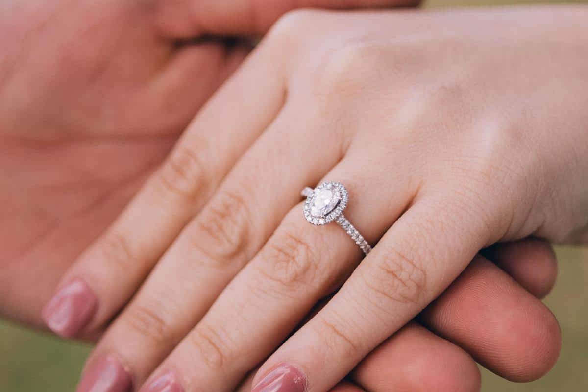 Engagement ring on a ladies slender hand.