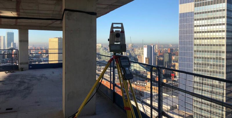 Setting out beside a concrete pillar.