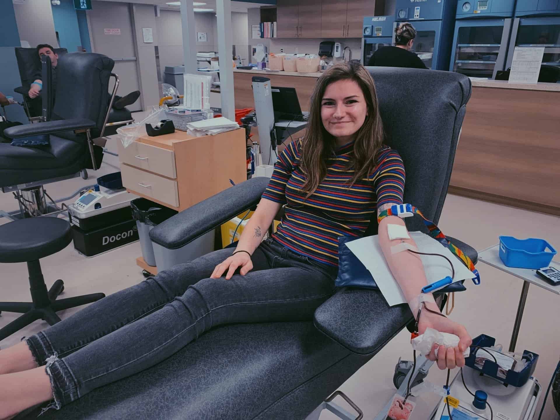 woman donates blood at clinic