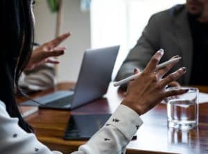 Business meeting with professionals using laptops and smartphones.
