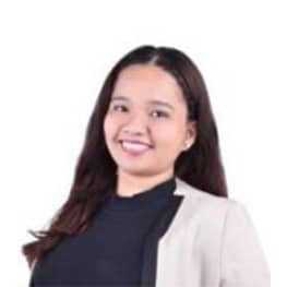 Young woman smiling in professional attire, portrait.
