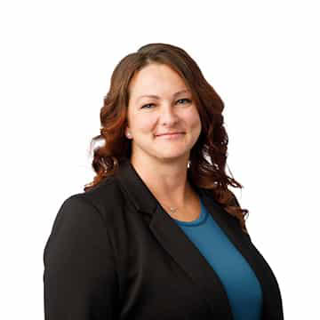 Businesswoman smiling confidently in professional attire for corporate success.
